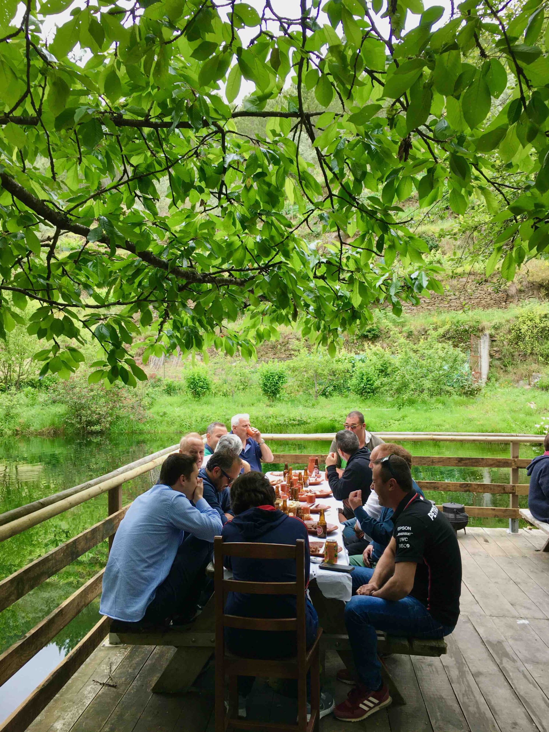 a group of people sitting on a bench in a park