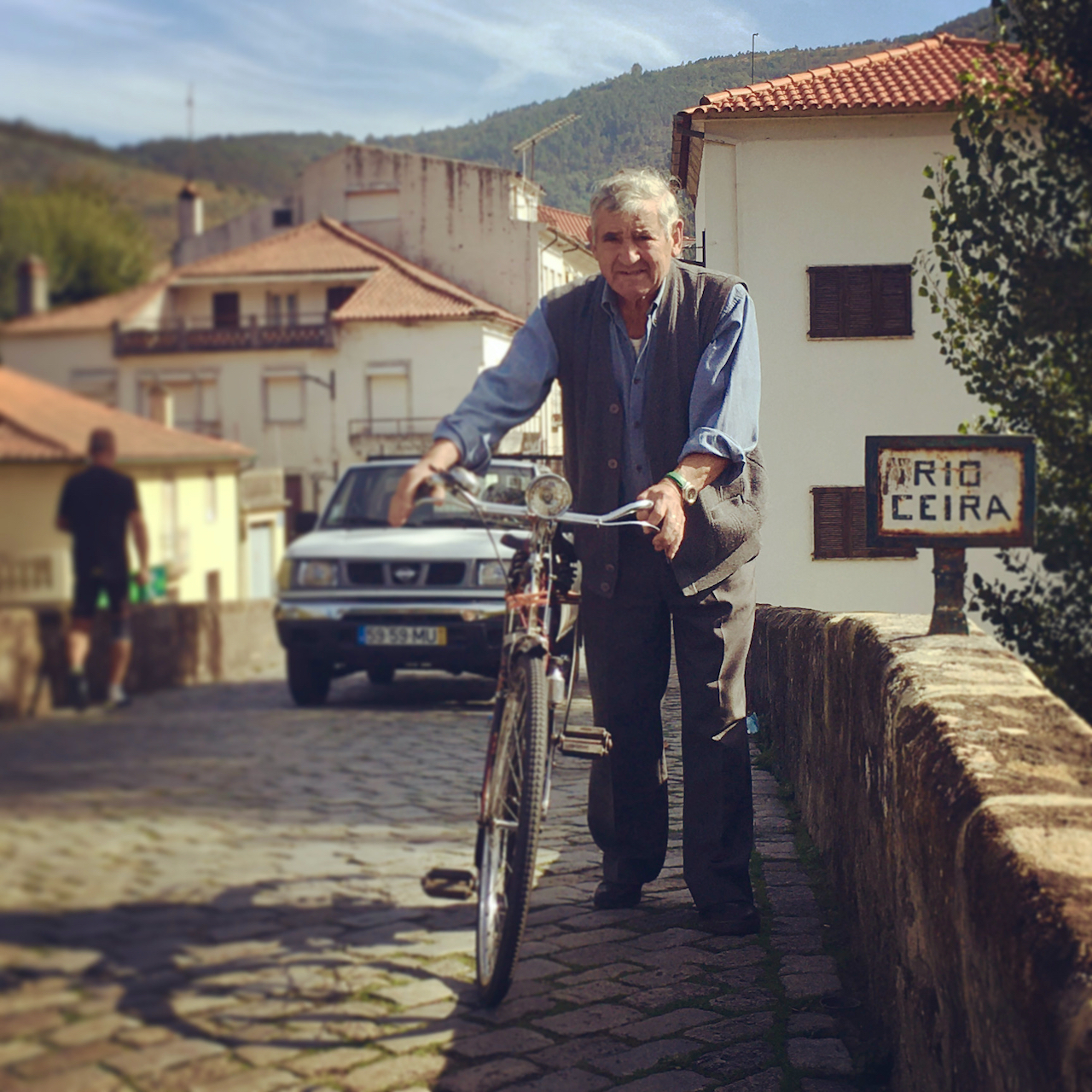 a man riding a bike down a dirt road