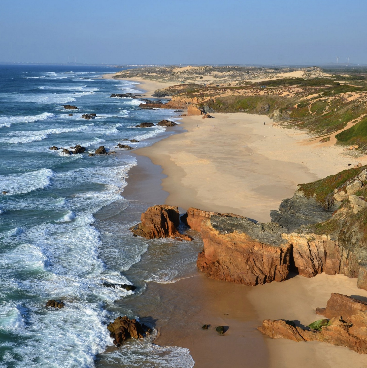 a rocky beach next to the ocean