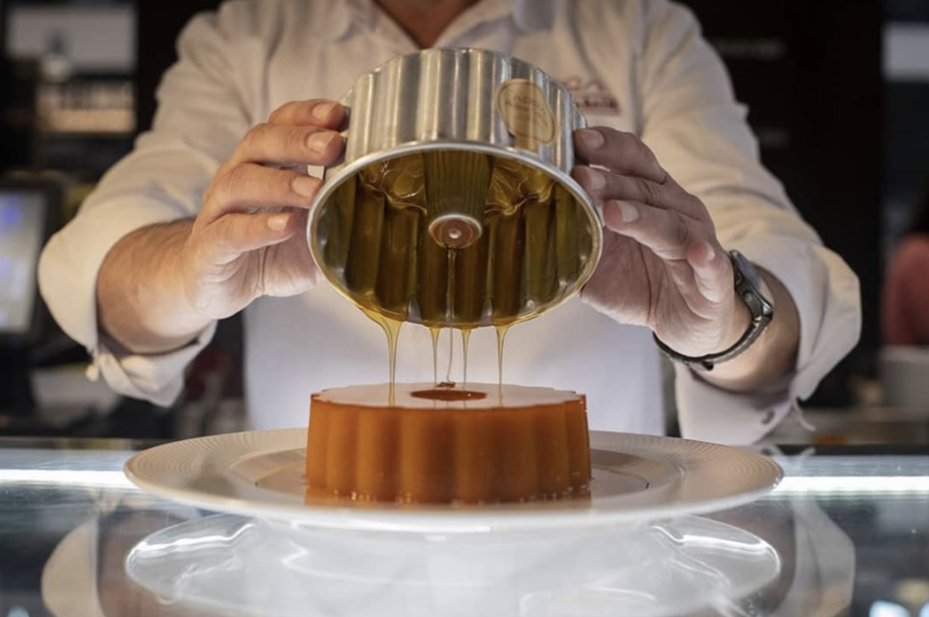 a person standing in front of a cake