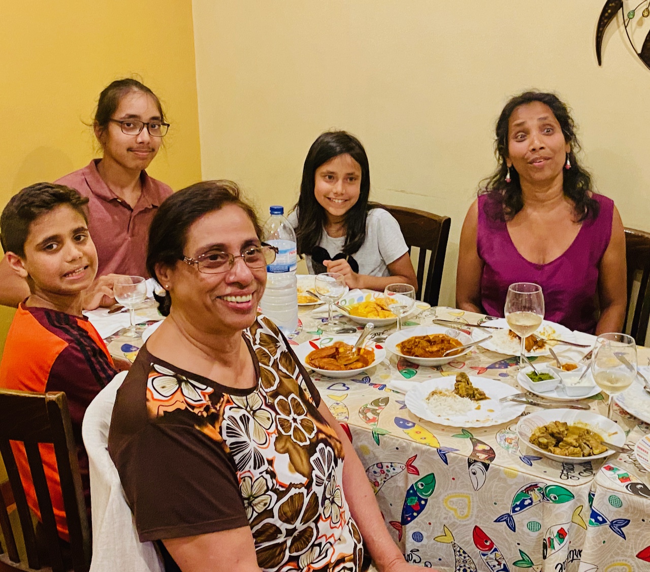 a group of people sitting at a table posing for the camera