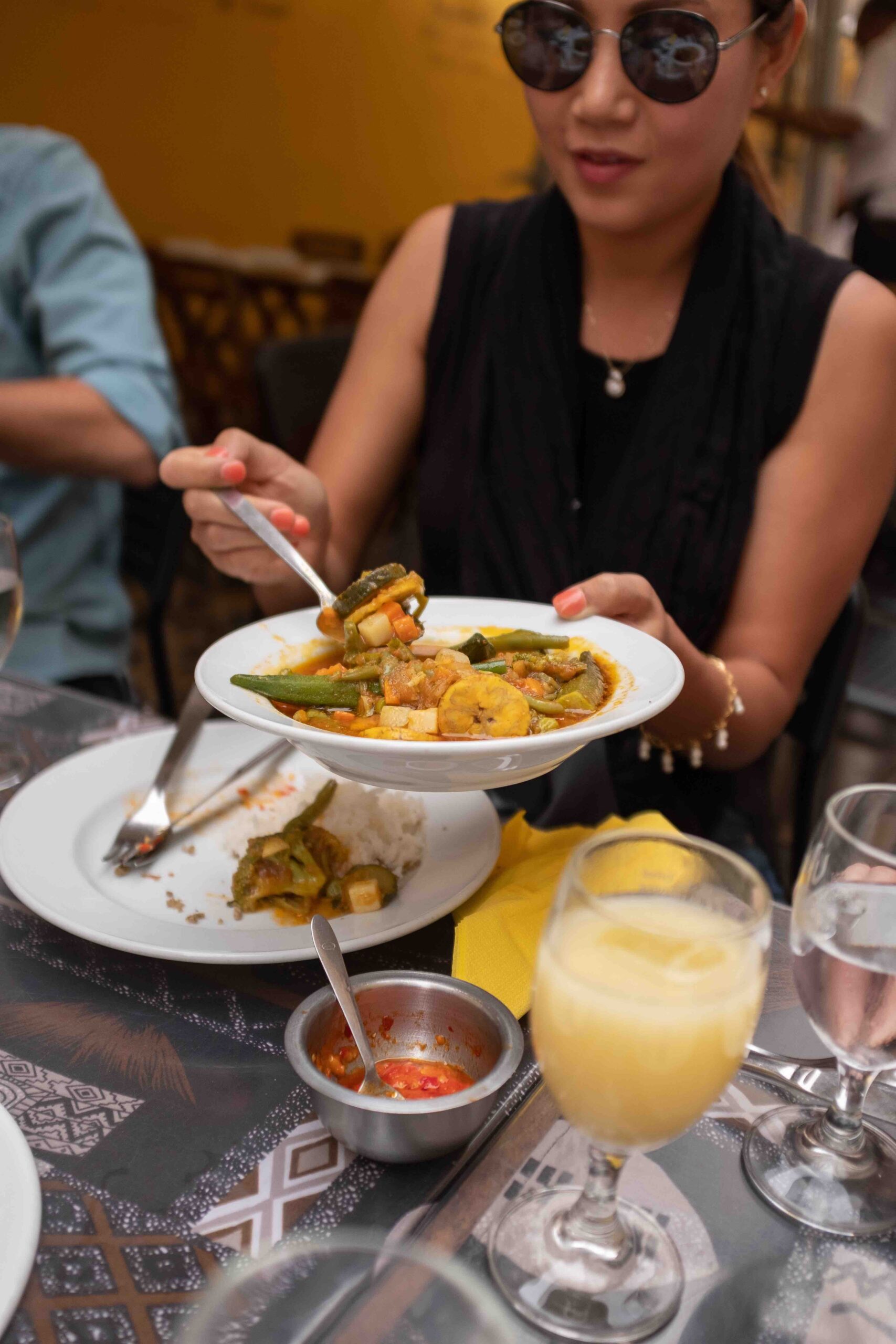 a person sitting at a table with a plate of food