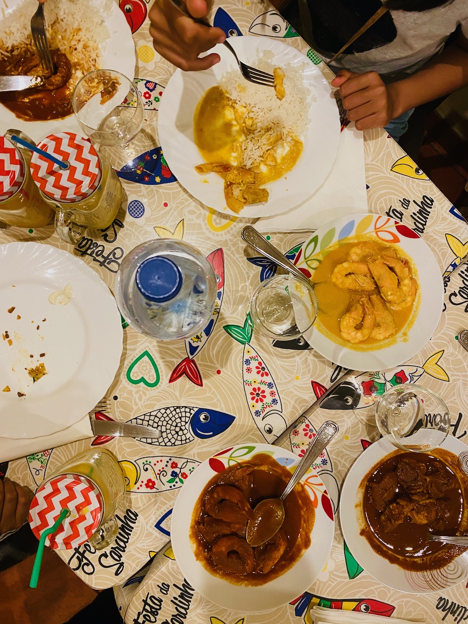 a group of people sitting at a table with a plate of food